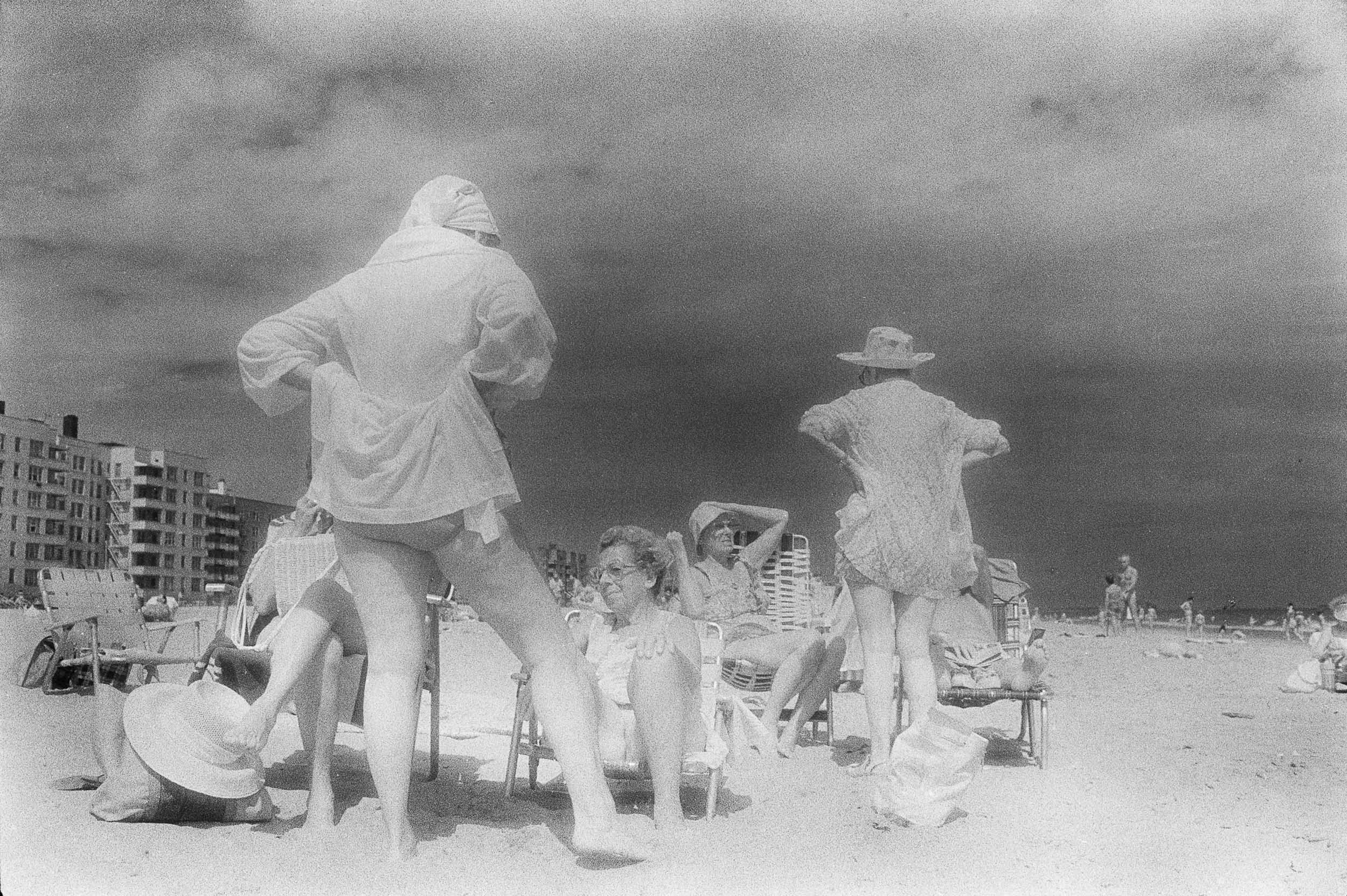 Barbara Alper- Photo of family talking and relaxing on Rockaway Beach NYC