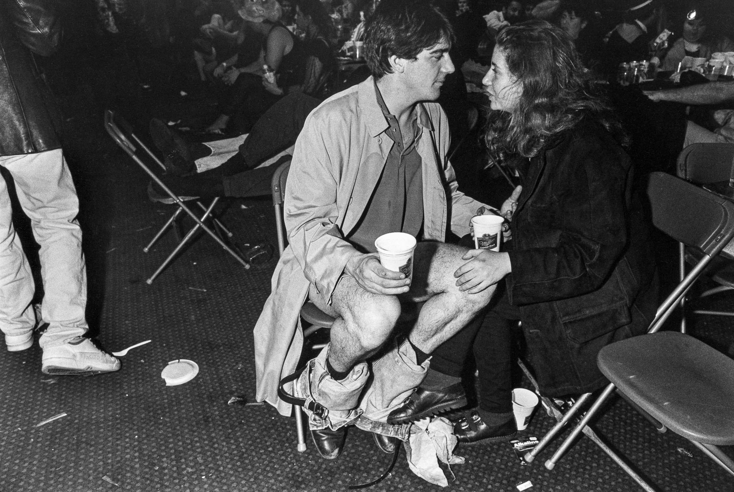 Barbara Alper- Photo of a man talking to a women with his pants down at the Exotic Erotic Ball, San Francisco